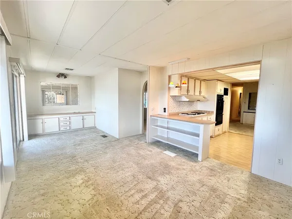 wooden floor in an empty room and a kitchen