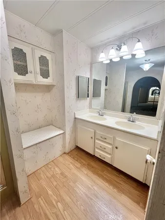 a bathroom with a double vanity sink and a mirror