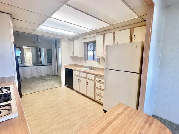 a kitchen with stainless steel appliances a refrigerator sink and cabinets