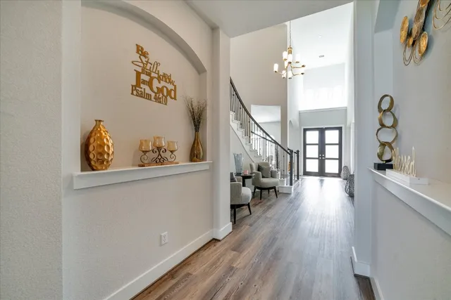 a bedroom with furniture and a wooden floor