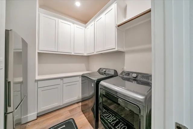 a kitchen with cabinets and wooden floor