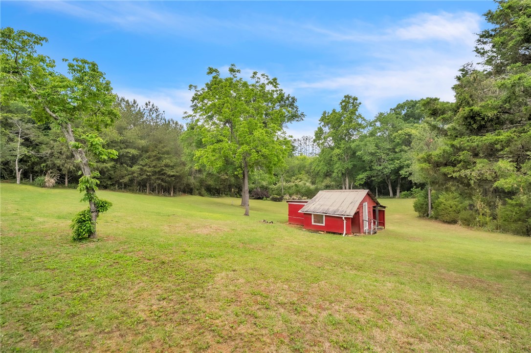 722 Lay Bridge Road Central, SC 29630 - Photo 28 of 32 Expansive green yard with a charming red shed, perfect for storage or creative projects.