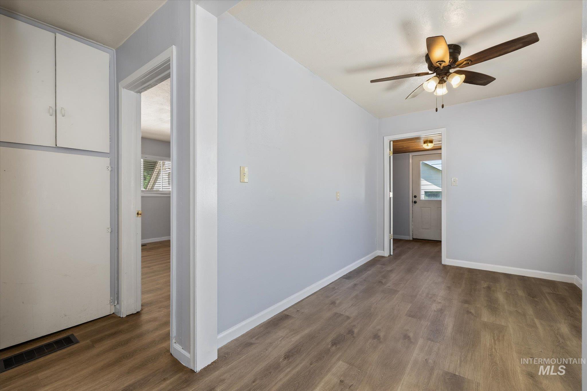 918 West 3rd Street Weiser, ID 83672 - Photo 19 of 36 Interior room featuring wood-finish flooring, light blue wall paint, and white baseboards