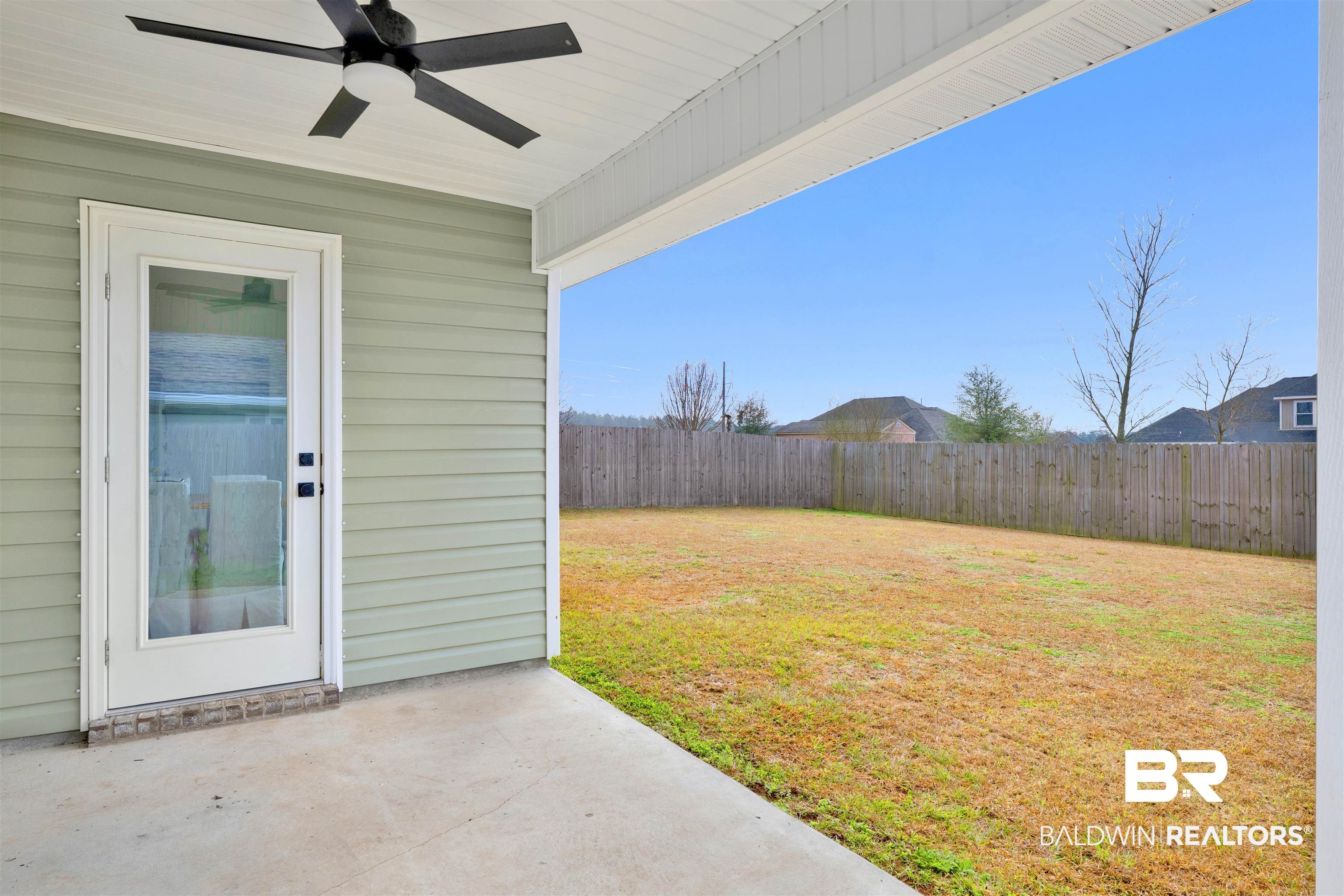 10763 Paget Drive North Mobile, AL 36608 - Photo 21 of 24 Fenced backyard featuring ceiling fan and a patio