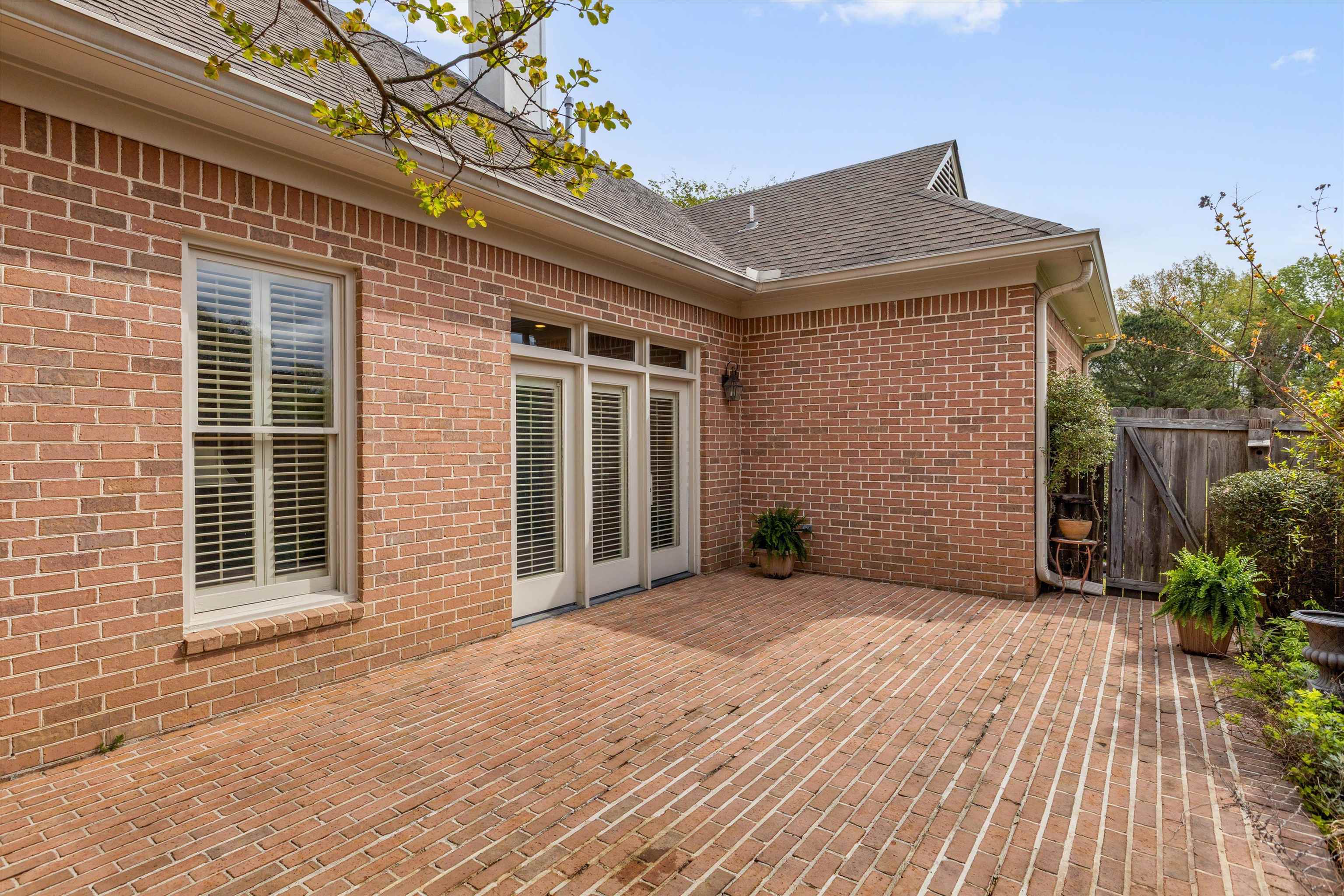 1707 Wainwright Court Collierville, TN 38017 - Photo 17 of 24 a view of backyard with plants and wooden fence