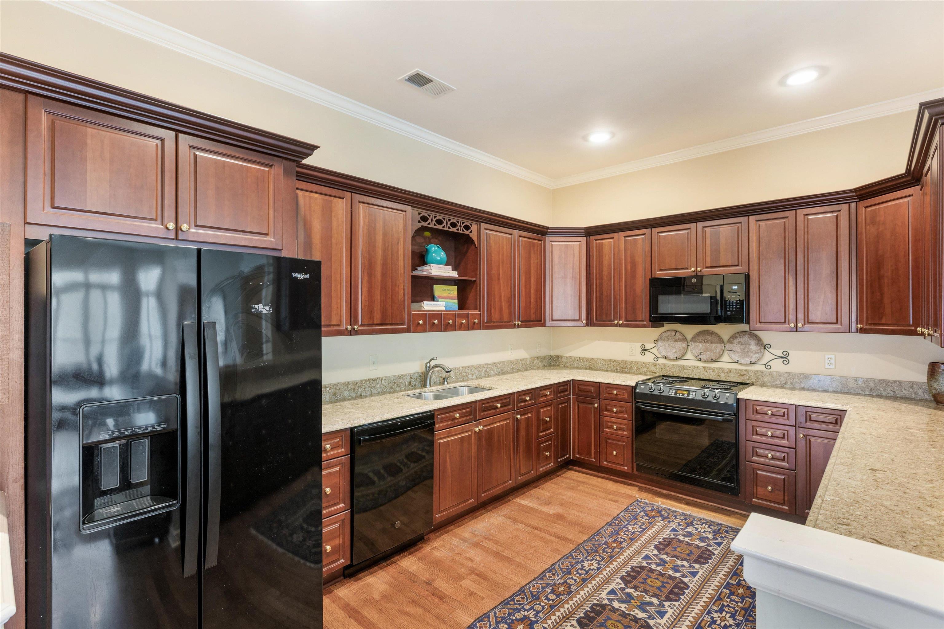 1707 Wainwright Court Collierville, TN 38017 - Photo 5 of 24 a kitchen with stainless steel appliances granite countertop a refrigerator stove and sink