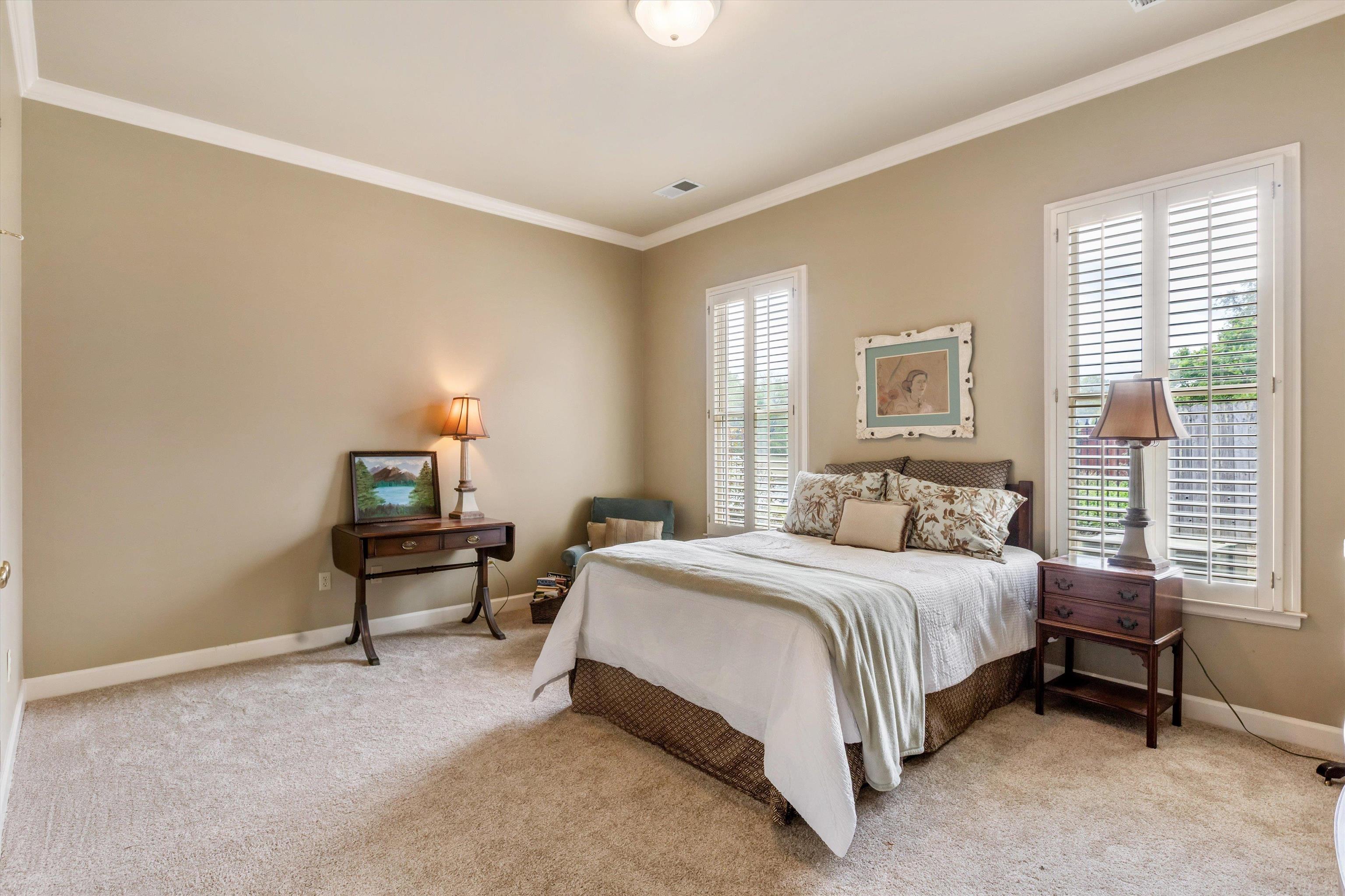 1707 Wainwright Court Collierville, TN 38017 - Photo 9 of 24 a bedroom with a bed table chair and a window