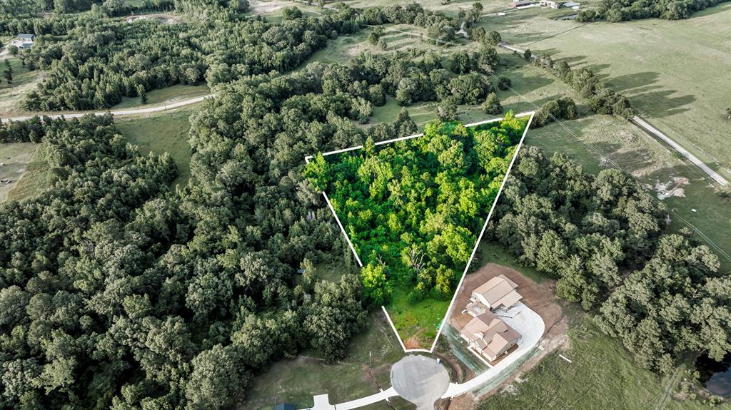 Aerial view of property and surrounding area with rural landscape and property parcel outlined