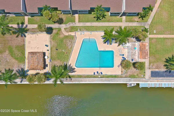 an aerial view of a house with a garden and lake view