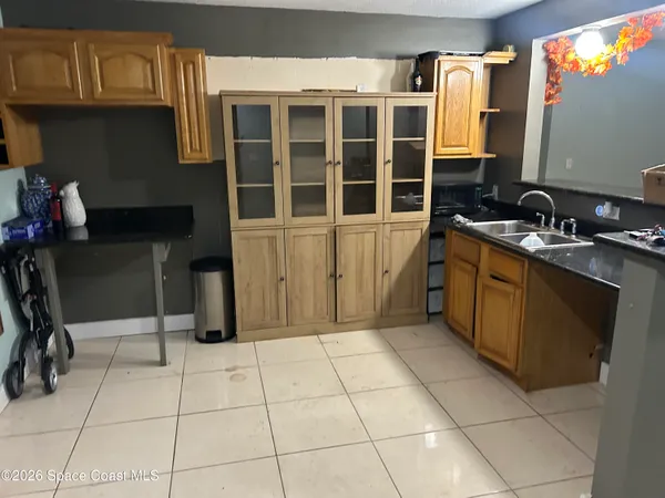 a kitchen with a sink a stove and cabinets