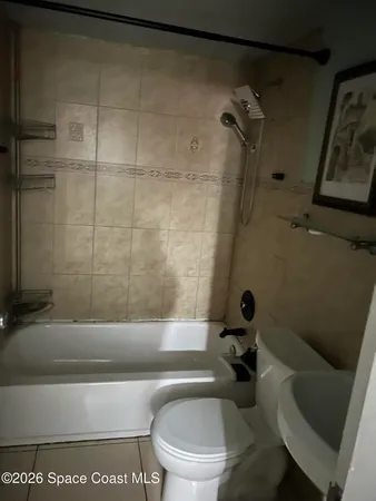 a bathroom with a toilet and a tub