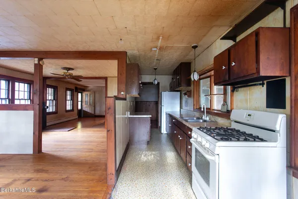 a kitchen with stainless steel appliances granite countertop a stove top oven a sink a counter space and cabinets