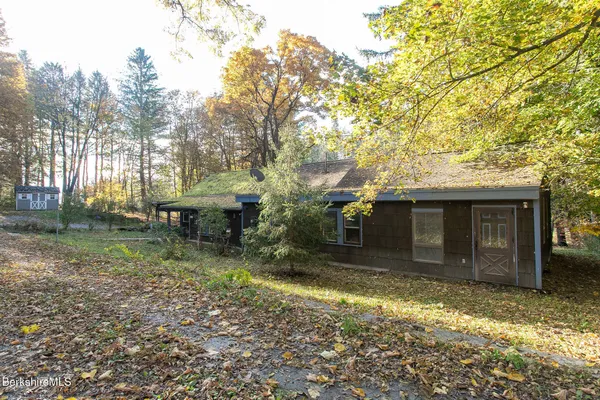 a view of a house with yard and sitting area