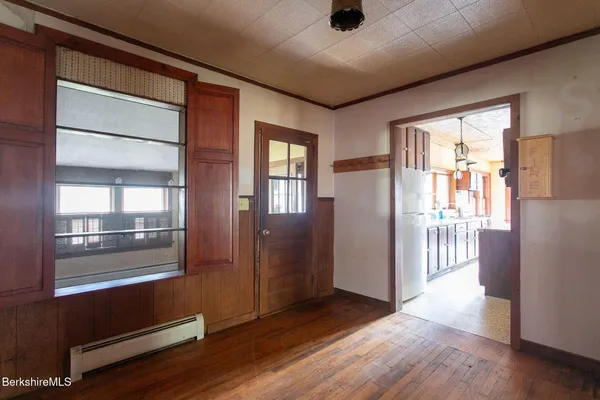 a view of a room with wooden floor and windows