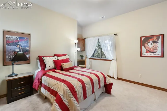 a bedroom with a bed and a painting on the wall