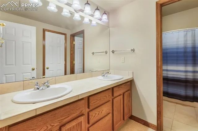 a bathroom with a sink double vanity and a mirror