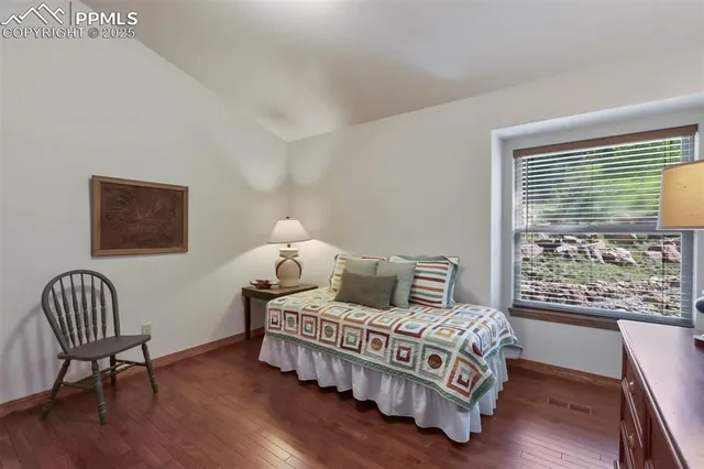 a bedroom with a bed chair and window