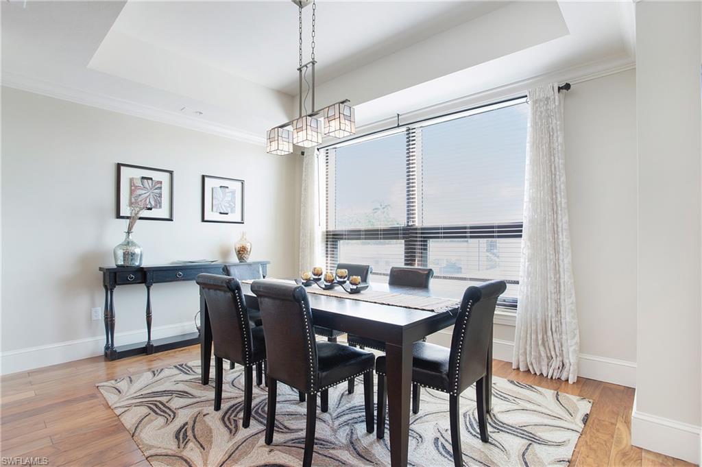 9123 Strada Place, Unit 7307 Naples, FL 34108 - Photo 20 of 49 a view of a dining room with furniture window and wooden floor