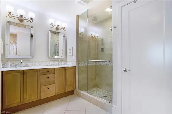 a bathroom with a tub a window and a shower