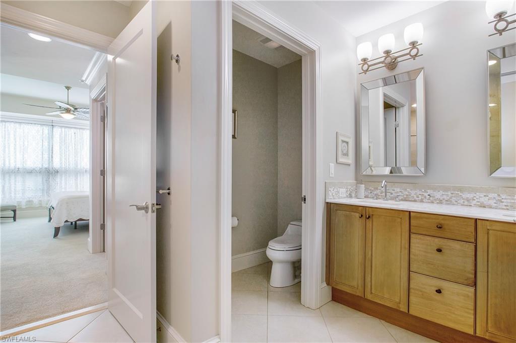 9123 Strada Place, Unit 7307 Naples, FL 34108 - Photo 25 of 49 a bathroom with a granite countertop sink toilet and shower