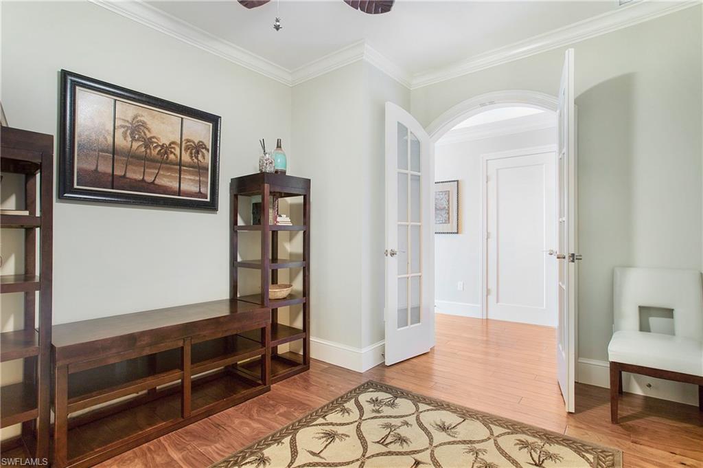 9123 Strada Place, Unit 7307 Naples, FL 34108 - Photo 29 of 49 a view of an empty room with wooden floor and a window