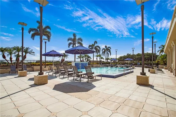 a swimming pool with outdoor seating and yard