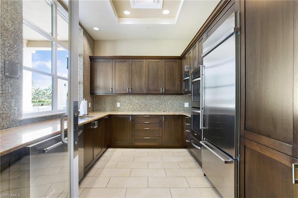 9123 Strada Place, Unit 7307 Naples, FL 34108 - Photo 47 of 49 a kitchen with a refrigerator and a sink