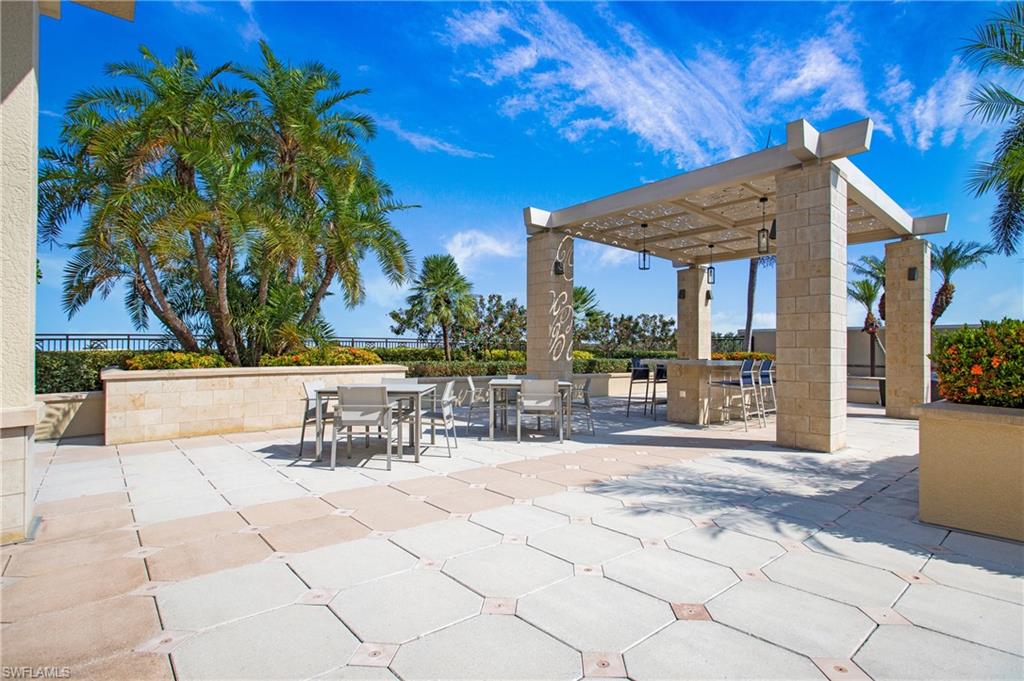 9123 Strada Place, Unit 7307 Naples, FL 34108 - Photo 48 of 49 a view of a chairs and tables in patio