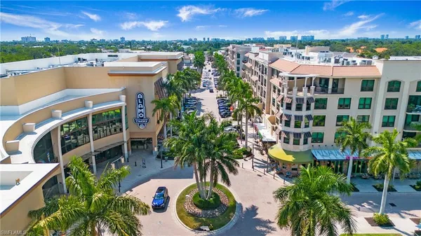 a view of a street with palm trees