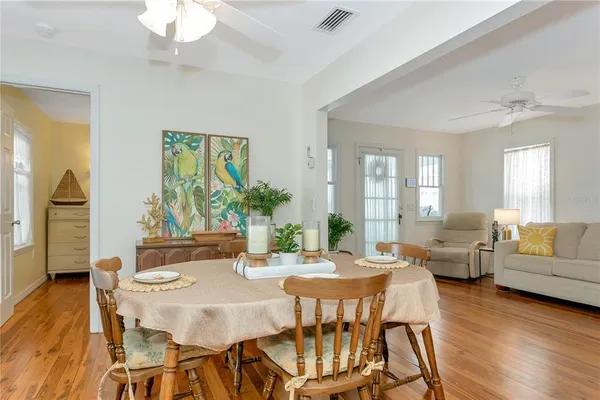 a view of a dining room with furniture window and wooden floor