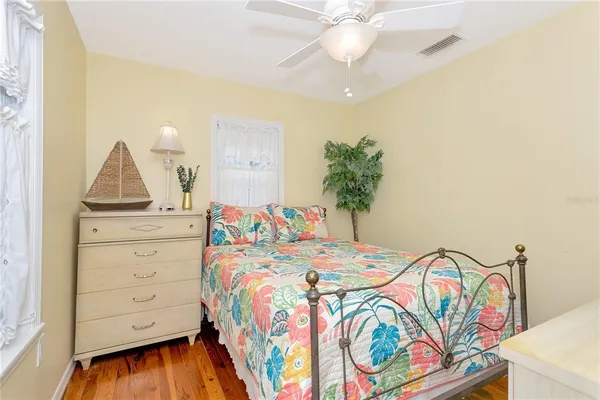 a bedroom with a bed and a dresser in it