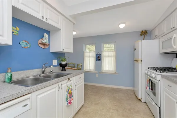 a kitchen that has a sink and a stove