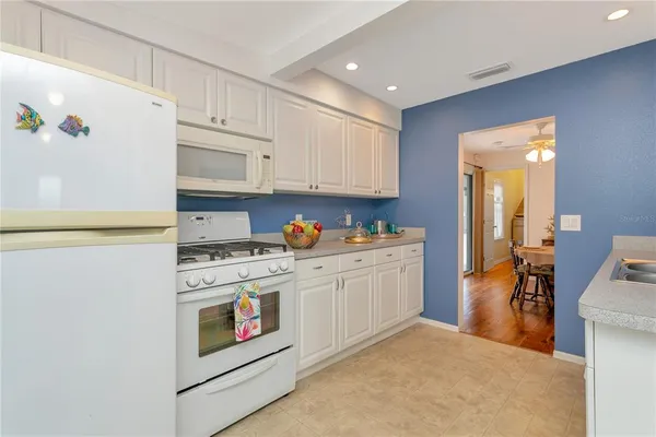 a kitchen with stainless steel appliances granite countertop a stove and a refrigerator