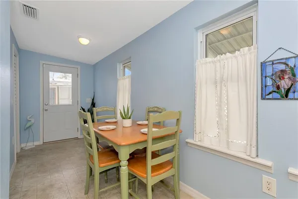 a dining room with furniture and window