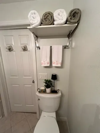a bathroom with a toilet a sink and a mirror