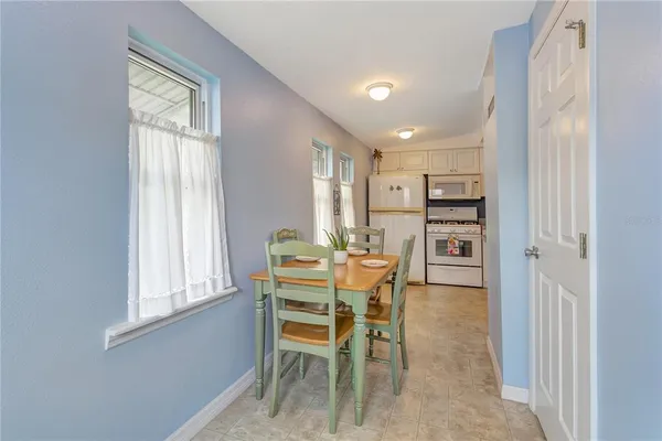a dining room with furniture and window