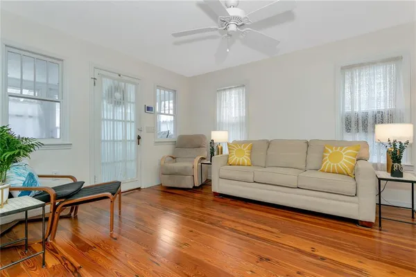 a living room with furniture and a wooden floor