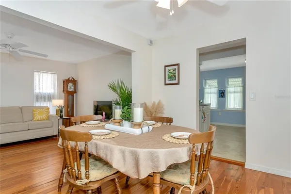 a view of a dining room with furniture and wooden floor