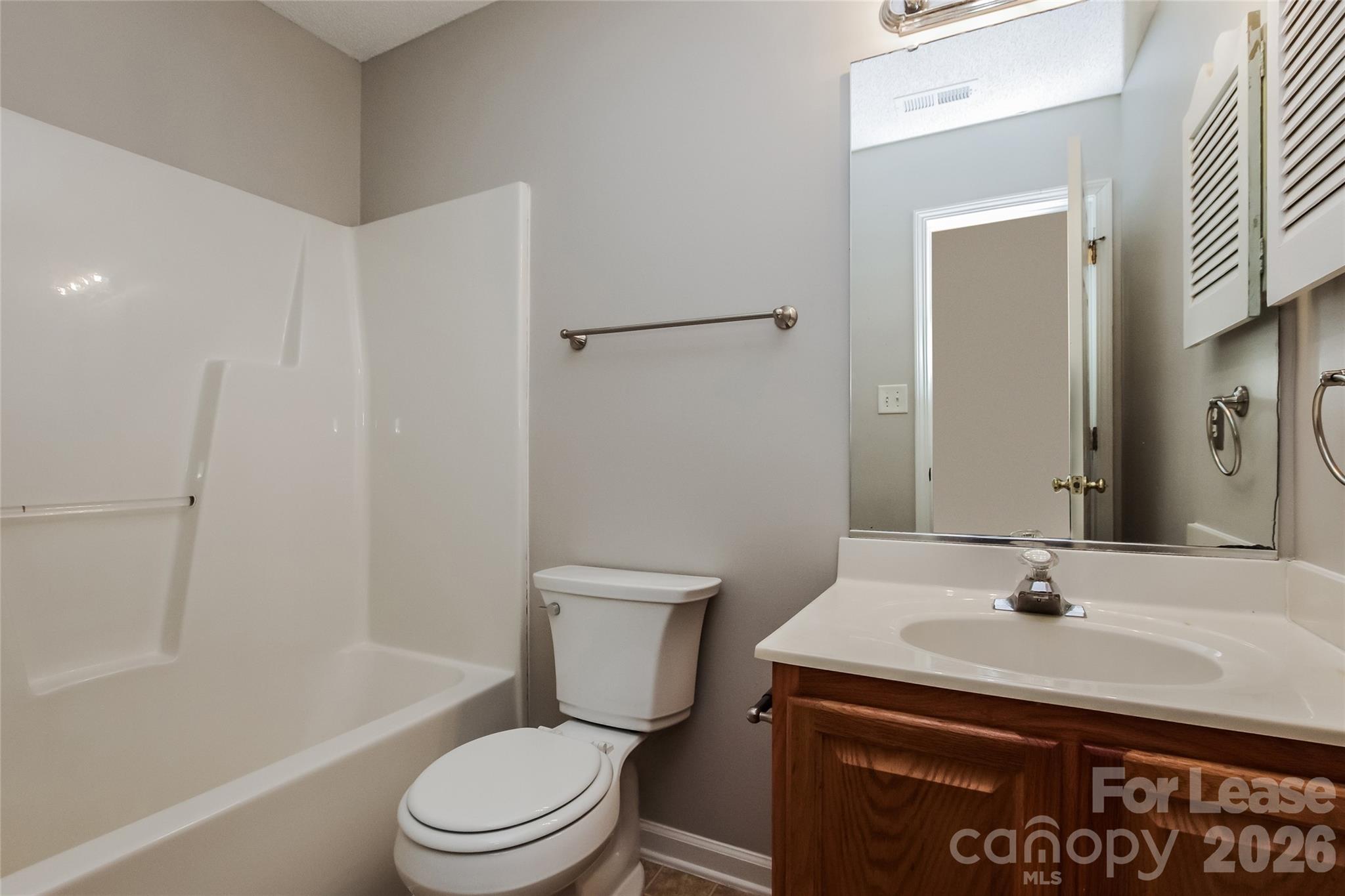 10802 Gold Pan Road Charlotte, NC 28215 - Photo 14 of 15 a bathroom with a sink toilet and shower