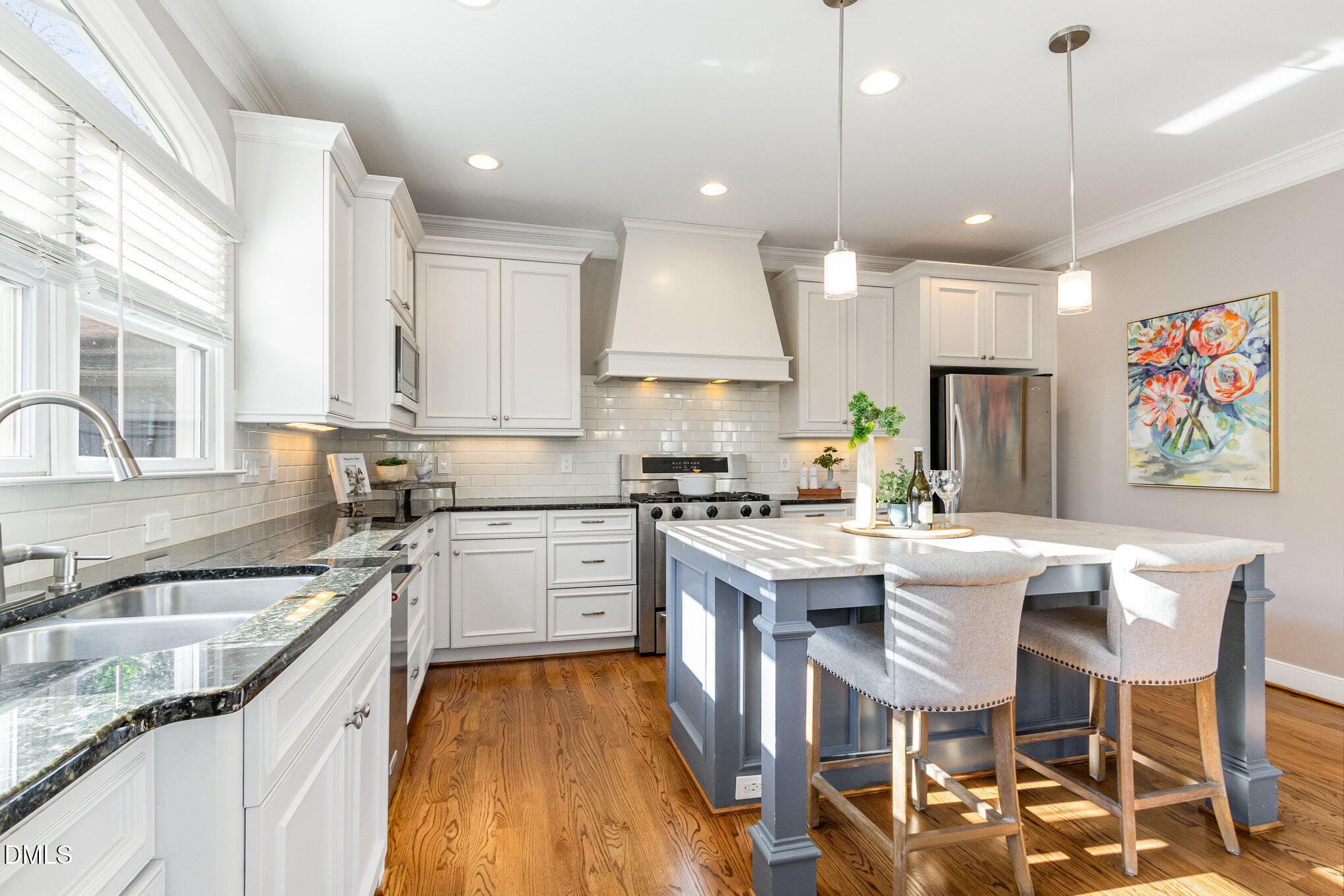 1340 Courtland Drive Raleigh, NC 27604 - Photo 16 of 42 a open kitchen with stainless steel appliances granite countertop a stove top oven a sink a dining table and chairs with wooden floor