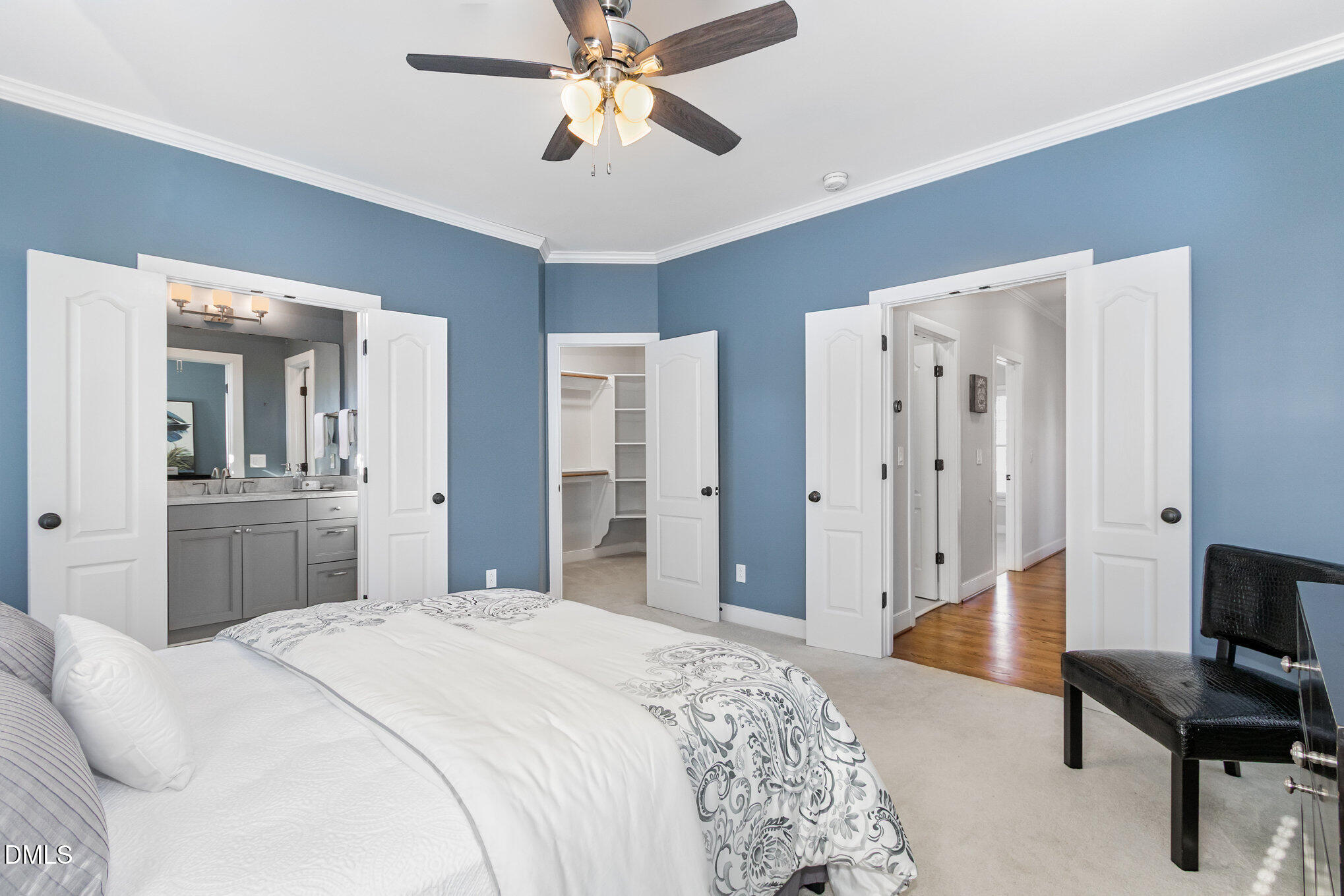 1340 Courtland Drive Raleigh, NC 27604 - Photo 20 of 42 a bedroom with a bed and a chandelier