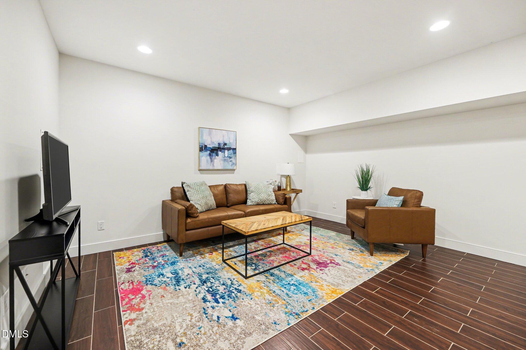 1340 Courtland Drive Raleigh, NC 27604 - Photo 27 of 42 a living room with furniture and a flat screen tv