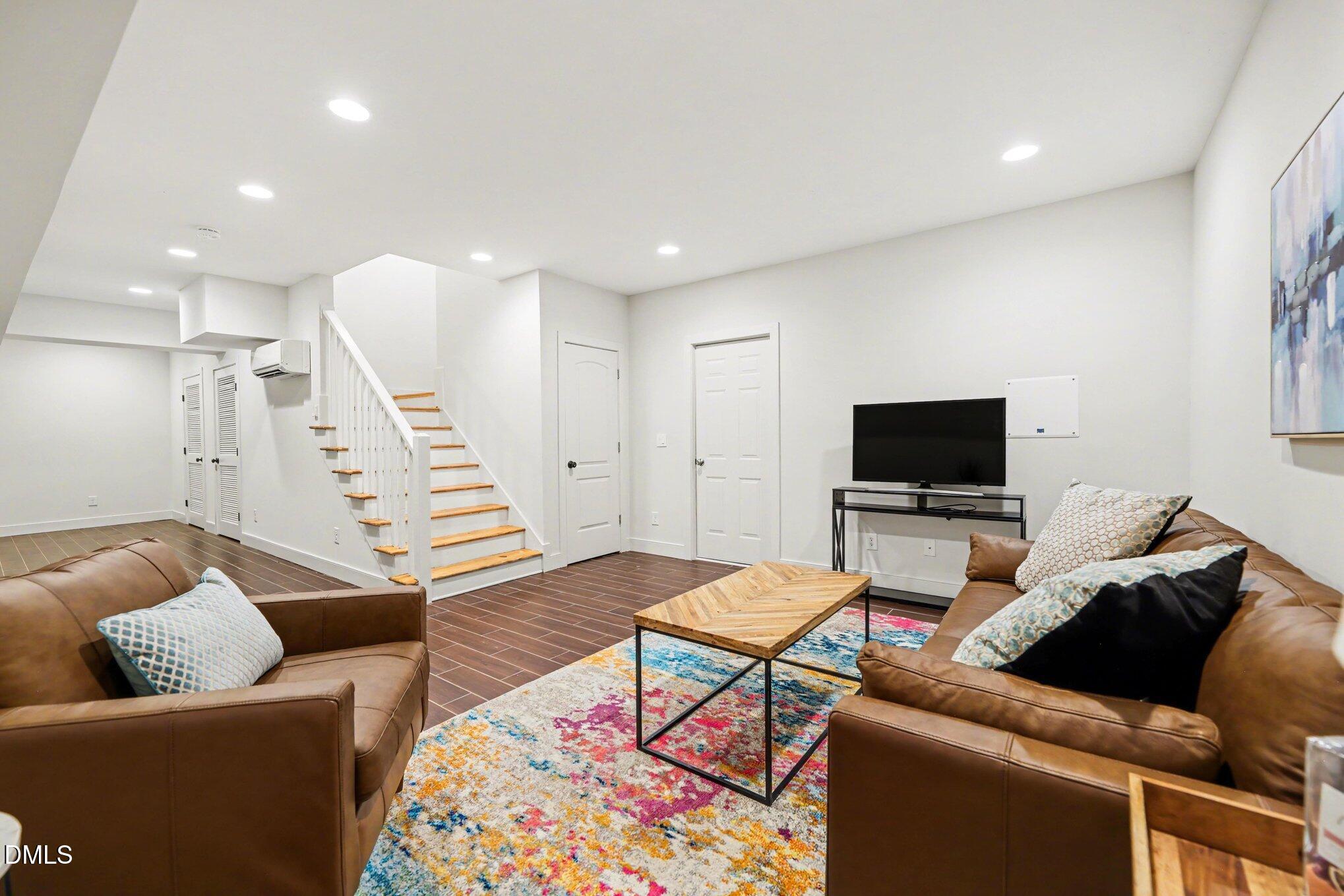 1340 Courtland Drive Raleigh, NC 27604 - Photo 28 of 42 a living room with furniture and a flat screen tv
