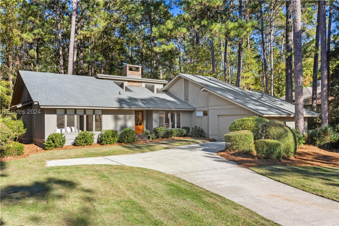 21 Newhall Road Hilton Head Island, SC 29928 - Photo 1 of 1 View of front of house with a front yard and a gar