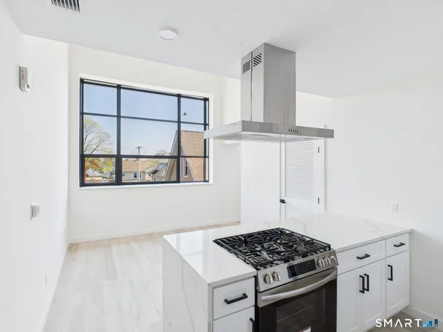 a kitchen with white cabinets and a stove