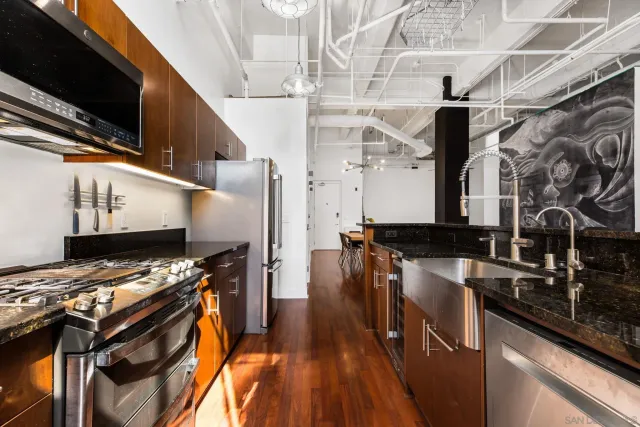 a kitchen with stainless steel appliances granite countertop a stove and a microwave
