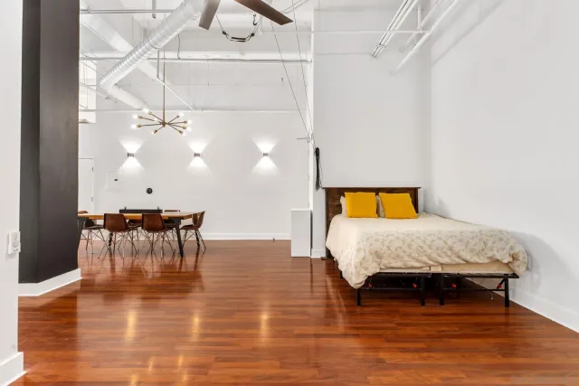 a bedroom with a bed and a chandelier