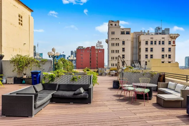 a view of a balcony with couch and potted plants