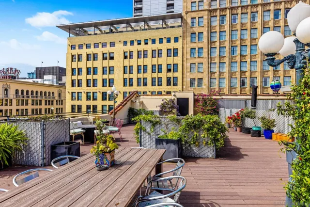 a view of a balcony with chairs and potted plants