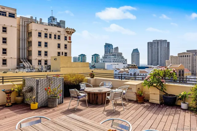 a view of a balcony with dining table and chairs